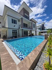 a villa with a swimming pool in front of a house at Baydream Villa - NEW Private Pool in Langkawi Islands