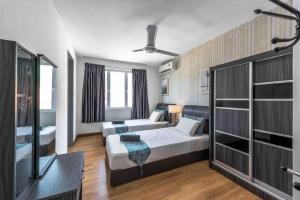 a hotel room with a bed and a tv at Baydream Villa - NEW Private Pool in Langkawi Islands +23 photos