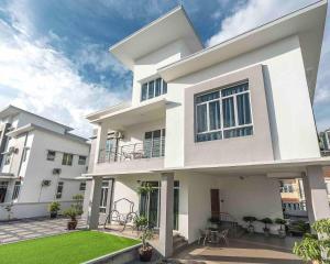 a white house with a lawn in front of it at Baydream Villa - NEW Private Pool in Langkawi Islands