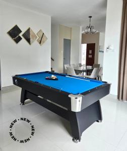a pool table sitting in a living room with at Baydream Villa - NEW Private Pool in Langkawi Islands