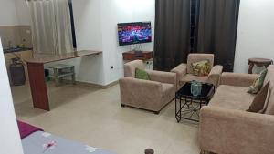 A television and/or entertainment centre at Kyle Calangute 1 bhk luxury apartment with pool