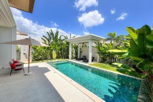 a swimming pool in the backyard of a villa at Modern 3BR Pool Villa T-Breeze in Laguna Phuket