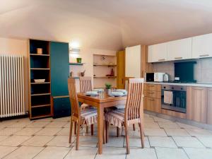 a kitchen with a wooden table and chairs at Centro di Bergamo - Nel Borgo in Bergamo