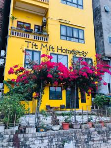 a yellow building with a sign that reads its muppet housekeeper at Tít Mít HomeStay in Cao Bằng