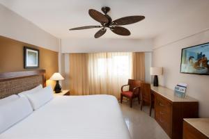 a bedroom with a bed and a ceiling fan at Occidental Caribe - All Inclusive in Punta Cana