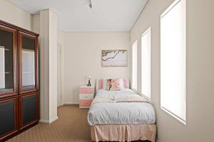 a white bedroom with a bed and a window at Tranquil Waterfront Single Room in Caringbah South - Stunning Views - Shared Bathroom in Lilli Pilli +84 photos