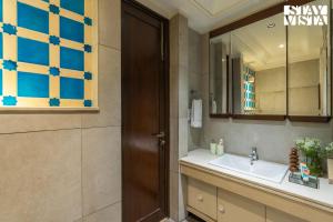 a bathroom with a sink and a mirror at StayVista at Albatross Haven with BBQ & Bonfire in Noida +21 photos