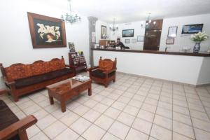 a waiting room with couches and a counter in a pharmacy at Hotel Arcada San Miguel de Allende in San Miguel de Allende