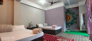 Postelja oz. postelje v sobi nastanitve Hotel TAMU ilam