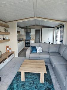 a living room with a couch and a coffee table at Relax - recharge - reignite in Llanwnda