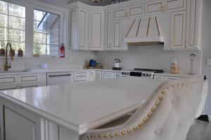 a kitchen with white cabinets and a white counter top at VIP Mansion Estate in Blakeslee +141 photos