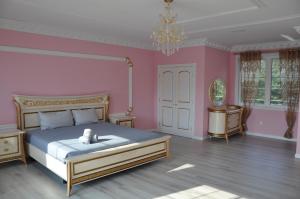 a bedroom with a bed and a pink wall at VIP Mansion Estate in Blakeslee