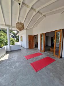 a large room with red mats on the floor at Athmaya Villa, Ahangama in Ahangama