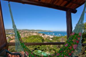 a hammock in a room with a view of the ocean at Bliss Hotéis Concept in Búzios