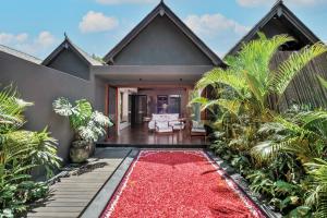 a house with a red carpet in front of it at Mayaloka Villas Ubud in Ubud +47 photos