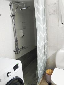 a shower with a washing machine in a bathroom at Harmony home in Ierapetra +17 photos
