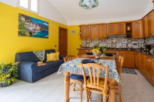 a kitchen and dining room with a table and a couch at SERHOUSE in Atrani +36 photos