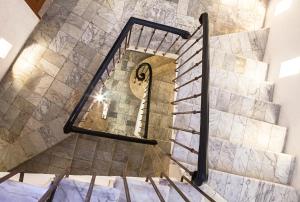 a spiral staircase in a building with a mirror at Hotel Boutique Casa del Coliseo in Cartagena de Indias +122 photos