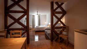 a room with two wooden doors and a living room at GS Chiado Boutique Studios & Suites in Lisbon
