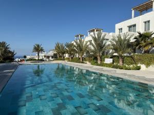 a swimming pool in front of a building at Terra in Elea