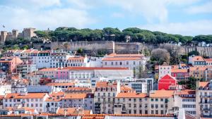 a city with buildings and a castle in the background at GS Chiado Boutique Studios & Suites in Lisbon