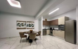 a kitchen and dining room with a table and chairs at Cosmos Residence in Paralimni