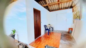 a dining room with a table and a blue chair at neena s Dormitory in Ko Phangan