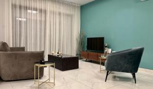 a living room with a couch and a television at Cosmos Residence in Paralimni
