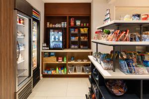 a grocery store aisle with a refrigerator and shelves at DoubleTree By Hilton Baltimore North Pikesville in Pikesville