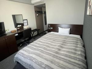 Postel nebo postele na pokoji v ubytování Hotel Route-Inn Shimodate