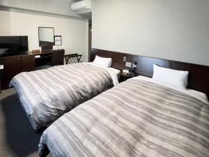 Postel nebo postele na pokoji v ubytování Hotel Route-Inn Shimodate