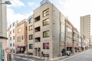 a tall building on a city street with buildings at jtr浅草橋302 in Tokyo
