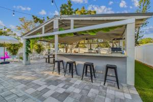 a patio with a bar with stools at Tampa Group Retreat l Pool l Hot Tub l Outdoor Fun! in Tampa