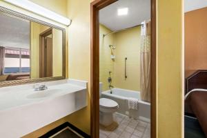 a bathroom with a sink and a toilet and a tub at Rodeway Inn Monroe in Monroe +30 photos