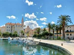 a group of boats in a body of water with buildings at Apartments Boguvila - One-Bedroom Apartment with Terrace A3 - ST in Supetar