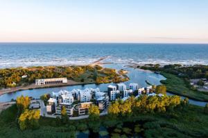 an aerial view of a house on an island in the water at Šventosios uostas in Palanga