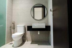 a bathroom with a white toilet and a mirror at Georgetown Greenish Kid-Friendly KTV 3BR 15pax B in George Town