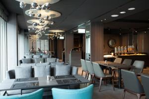 a restaurant with blue chairs and tables and a bar at Hotel Lainn in Kaohsiung