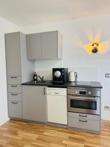 a kitchen with white cabinets and a stove at Romantica in Rust