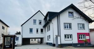 a white house with a black roof at Pension Romantica, Appartment Diana in Rust