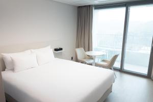 Postel nebo postele na pokoji v ubytování Hotel Wavellent Yangyang