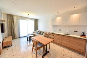 a kitchen and living room with a table and a couch at Avilia Suites in Fethiye