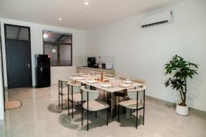 a dining room with a table and chairs and a kitchen at Georgetown Elegant Golden Jacuzzi KTV 5BR 16pax E in George Town +73 photos