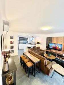 a living room with a couch and a table at 2 bedroom Townhouse at Ayi Mensah Park at the foot of Aburi Mountains in Aiyimensa