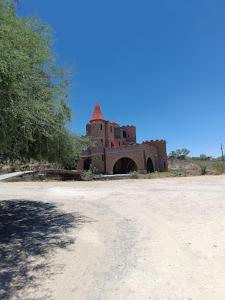 an old building in the middle of a dirt road at Castillo Palmas in Aguascalientes
