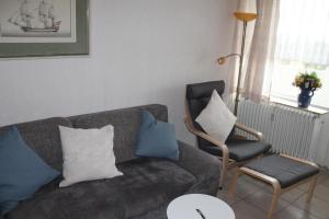 a living room with a couch and a chair at Ferienwohnung L412 für 2-4 Personen an der Ostsee in Schönberg in Holstein +1 photo