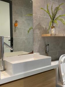 a bathroom with a white sink and a mirror at The Local Villa Danang in Da Nang