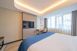 Katil atau katil-katil dalam bilik di Yunfei Hotel - Shanghai Hongqiao Wuzhong Road Branch
