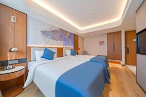 Katil atau katil-katil dalam bilik di Yunfei Hotel - Shanghai Hongqiao Wuzhong Road Branch
