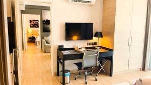 マラッカにあるASIA MELAKA HOTEL managed by The Straits Hotel & Suites 马六甲亚逸酒店のデスク、壁掛けテレビが備わる客室です。